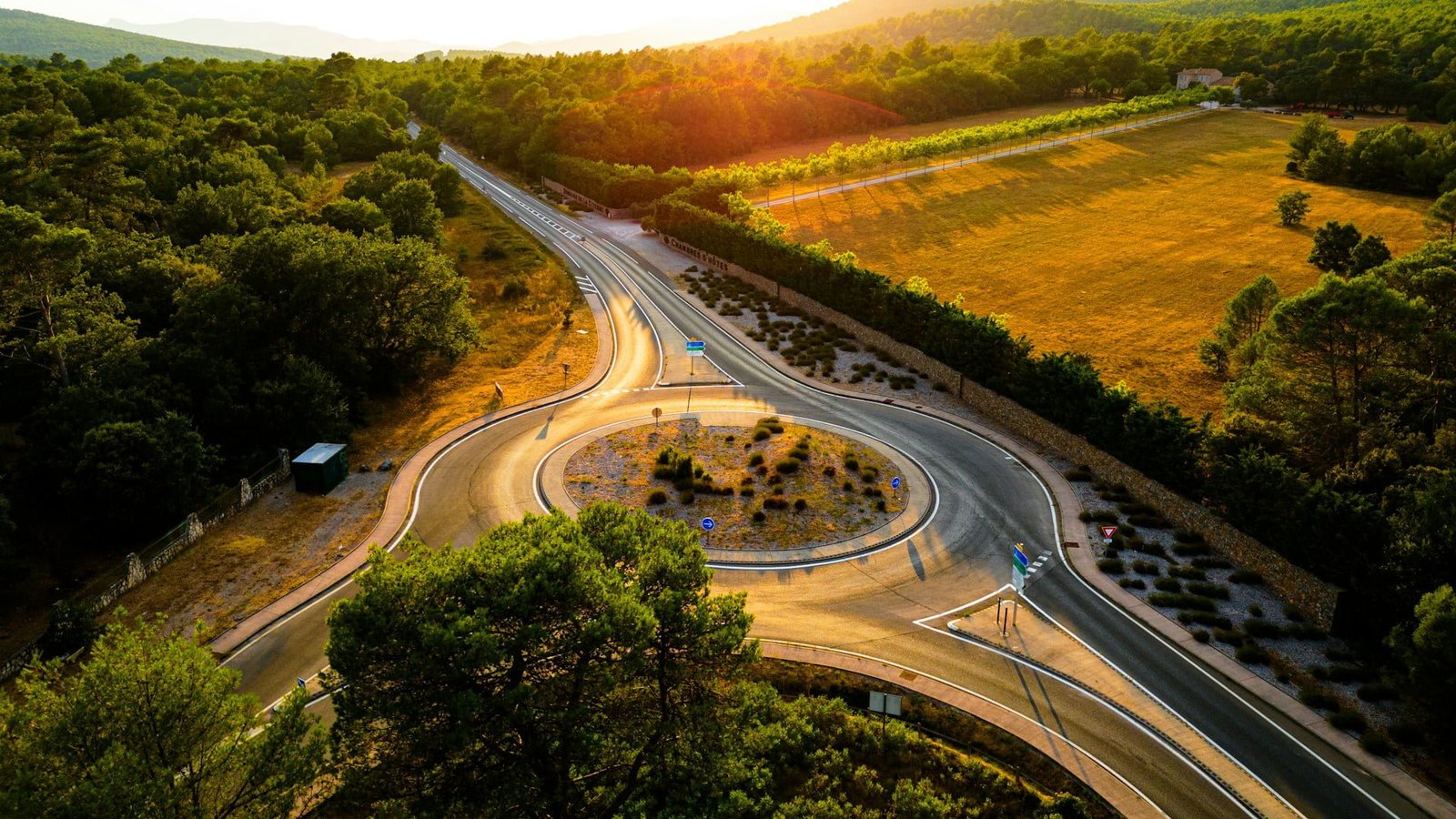 Aerial view of mountains, field and road from a drone in south of France