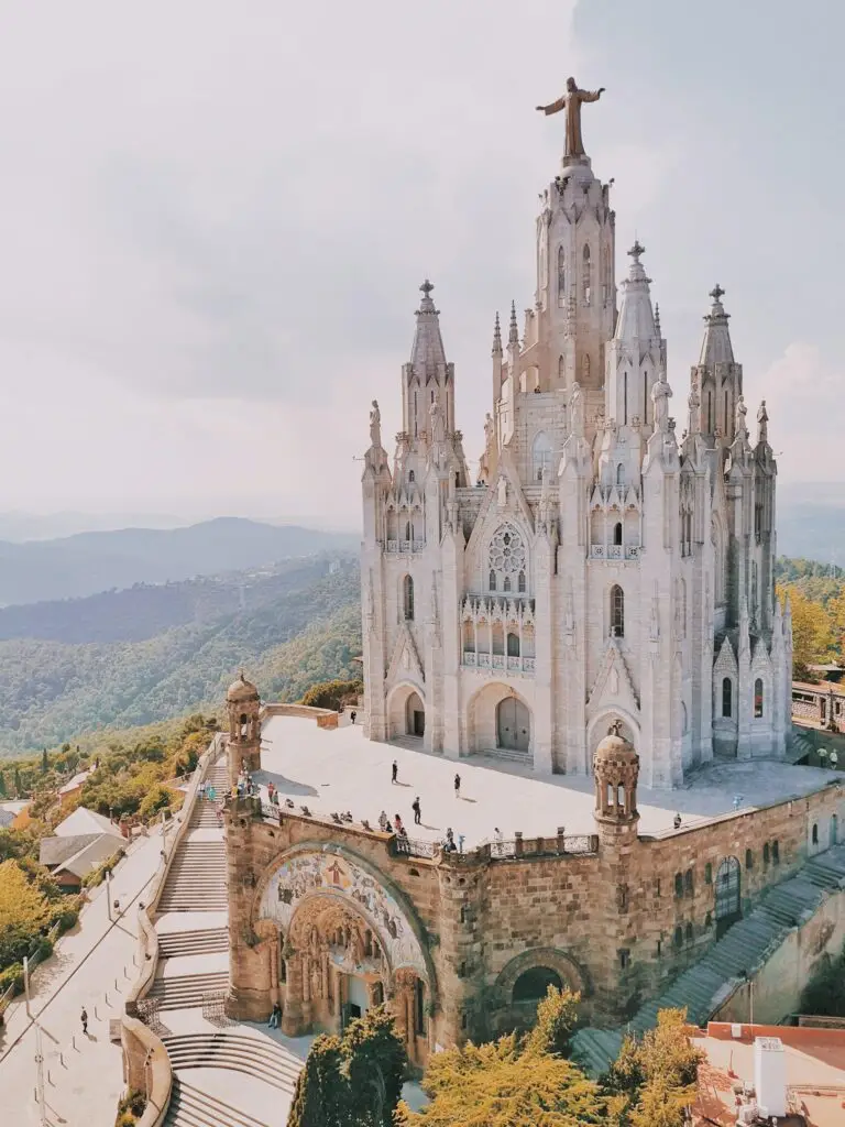 Why visit Spain? Explore the breathtaking Temple Expiatori del Sagrat Cor in Barcelona, an architectural masterpiece perched atop Mount Tibidabo with panoramic views of the city's landscape.