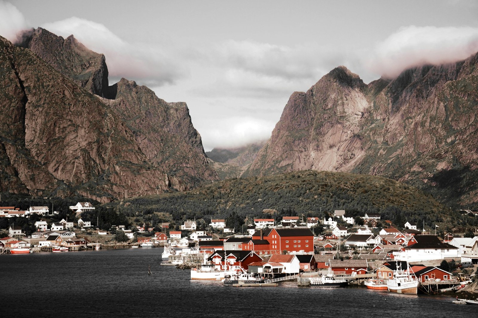 A charming fishing village surrounded by towering mountains and calm waters, showcasing why people ask, "Is Norway a Good Place to Visit?"