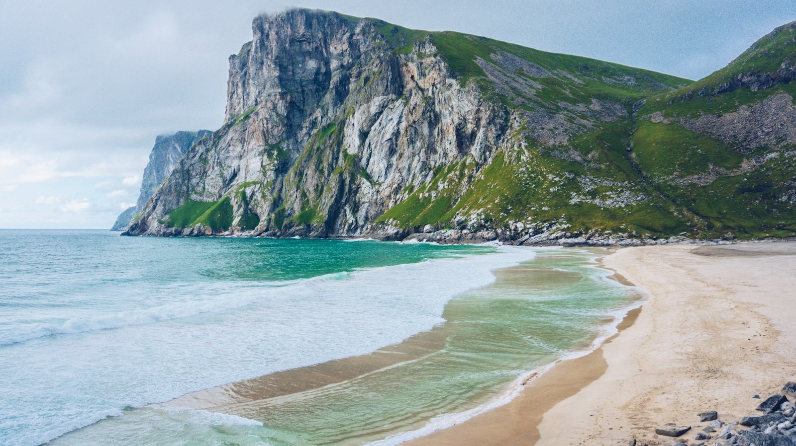 Stunning view of Kvalvika Beach, Moskenes, Norway, with cliffs and clear waves during a trip to Norway.